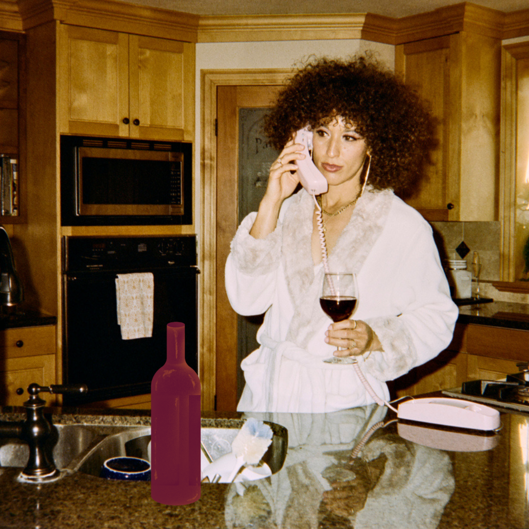 woman on phone enjoying wine