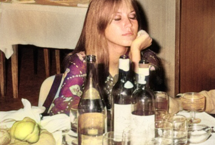 1960s woman at table with wine